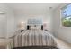 Bright bedroom featuring a comfortable queen bed, neutral décor, and natural light at 3329 Molly Ln, Broomfield, CO 80023