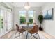 Bright dining area with a modern table, seating, and large windows at 3329 Molly Ln, Broomfield, CO 80023