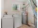 Functional laundry room with a washer, dryer, and water heater at 3329 Molly Ln, Broomfield, CO 80023