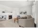 Bright living room with neutral tones, large windows, and a cozy fireplace at 3329 Molly Ln, Broomfield, CO 80023