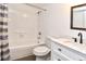 Bathroom features shower over tub, tiled surround, and modern vanity with black faucet at 12024 W Cross Dr # 106, Littleton, CO 80127