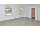 Bright bedroom with two large windows and closet space; bathroom can be seen in background at 12024 W Cross Dr # 106, Littleton, CO 80127