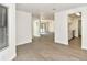 Open floor plan featuring modern flooring leads from a bright living area to the updated kitchen at 12024 W Cross Dr # 106, Littleton, CO 80127