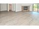 Living room with modern flooring and stone fireplace; bathroom with shower and vanity can be seen in background at 12024 W Cross Dr # 106, Littleton, CO 80127