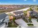 Desirable two-story home boasts a three-car garage, brick facade, landscaping, and a prime location near a pond at 7207 S Scottsburg Way, Aurora, CO 80016