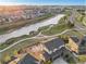 Desirable two-story home boasts a three-car garage, brick facade, landscaping, and a prime location near a pond at 7207 S Scottsburg Way, Aurora, CO 80016