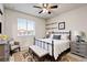Charming bedroom with a black iron bed frame and a comfortable sitting area at 7207 S Scottsburg Way, Aurora, CO 80016