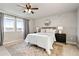 Bright bedroom featuring large windows, ceiling fan, and stylish furniture at 7207 S Scottsburg Way, Aurora, CO 80016