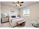 Comfortable bedroom with a plush bed, stylish rug, and natural light streaming through the window at 7207 S Scottsburg Way, Aurora, CO 80016
