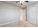 A cozy bedroom featuring neutral walls, carpet flooring, and a ceiling fan with overhead lighting at 7207 S Scottsburg Way, Aurora, CO 80016