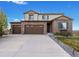 Charming two-story home featuring a three-car garage, brick facade, landscaped yard and inviting front door at 7207 S Scottsburg Way, Aurora, CO 80016