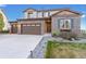 Charming two-story home featuring a three-car garage, brick facade, landscaped yard and inviting front door at 7207 S Scottsburg Way, Aurora, CO 80016
