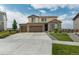 Inviting two-story home with a three-car garage, a wide driveway, a well-maintained lawn, and mature trees at 7207 S Scottsburg Way, Aurora, CO 80016