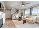 Cozy living room with a fireplace, comfortable seating, and natural light creating a warm and inviting atmosphere at 7207 S Scottsburg Way, Aurora, CO 80016