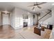 Spacious living room with a fireplace, hardwood floors, and ample natural light, perfect for relaxation and entertaining at 7207 S Scottsburg Way, Aurora, CO 80016