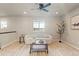 Bright loft area with a modern white sofa, stylish coffee table, and large windows at 7207 S Scottsburg Way, Aurora, CO 80016