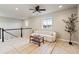 Inviting loft area with a cozy couch, stylish furnishings, and a ceiling fan for added comfort at 7207 S Scottsburg Way, Aurora, CO 80016