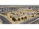Aerial view of a vibrant community park featuring a playground, basketball court, picnic areas, and landscaping at 24906 E Calhoun Pl # C, Aurora, CO 80016
