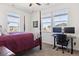 Serene bedroom features multiple bright windows, a dark wood poster bed, and an office space at 24906 E Calhoun Pl # C, Aurora, CO 80016