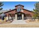 Attractive clubhouse featuring stone accents, a welcoming entryway, and well-maintained landscaping at 24906 E Calhoun Pl # C, Aurora, CO 80016
