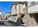 Charming townhome featuring stone accents, neutral siding, and a welcoming front entrance with decorative wreath at 24906 E Calhoun Pl # C, Aurora, CO 80016