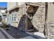 Inviting front door with stone surround and decorative wreath, enhancing curb appeal of the townhome at 24906 E Calhoun Pl # C, Aurora, CO 80016