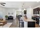 Modern open floor plan with kitchen island, dining area, and cozy living space at 24906 E Calhoun Pl # C, Aurora, CO 80016