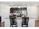 Well-appointed kitchen with granite countertops, stainless steel appliances, dark cabinets, and bar stool seating at 24906 E Calhoun Pl # C, Aurora, CO 80016