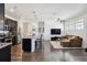Bright, open layout showcasing a modern kitchen with island, stainless steel appliances, and seamless flow to living area at 24906 E Calhoun Pl # C, Aurora, CO 80016