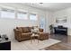 Comfortable living room with couch, piano, and bright natural light at 24906 E Calhoun Pl # C, Aurora, CO 80016