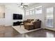 Cozy living room with a comfortable couch, TV, and plenty of natural light at 24906 E Calhoun Pl # C, Aurora, CO 80016