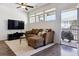 Cozy living room with a comfortable couch, TV, and a walk-out to the outdoor patio at 24906 E Calhoun Pl # C, Aurora, CO 80016