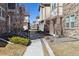 Townhome community showing street view, landscaping, and architectural details in neutral colors at 24906 E Calhoun Pl # C, Aurora, CO 80016