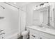 Bathroom with a shower-tub combo, marble countertop vanity, and modern lighting at 15732 E Broncos Pl, Englewood, CO 80112