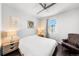 Cozy bedroom featuring wood floors, a plush armchair, neutral decor, and soft lighting at 15732 E Broncos Pl, Englewood, CO 80112