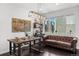 Cozy dining area with stylish seating, a decorative light fixture, and natural light at 15732 E Broncos Pl, Englewood, CO 80112