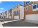 Street view of modern townhomes with attached garages at 15732 E Broncos Pl, Englewood, CO 80112