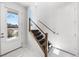 Bright and airy foyer with modern tile flooring and stylish staircase design at 15732 E Broncos Pl, Englewood, CO 80112