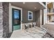 Charming front porch with seating and decorative stone accents on a modern townhome at 15732 E Broncos Pl, Englewood, CO 80112