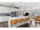 Modern kitchen with a large island, stainless steel appliances, and bar stool seating at 15732 E Broncos Pl, Englewood, CO 80112