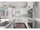 Contemporary kitchen features stainless steel appliances, ample cabinetry, and a stylish backsplash at 15732 E Broncos Pl, Englewood, CO 80112