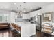 Bright kitchen boasts an island with quartz countertop and stainless steel appliances at 15732 E Broncos Pl, Englewood, CO 80112
