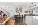 Open living space showcases stylish decor, a bar area, and ample natural light at 15732 E Broncos Pl, Englewood, CO 80112
