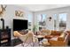 Bright living room boasts large windows, comfortable seating, and a stylish fireplace at 15732 E Broncos Pl, Englewood, CO 80112