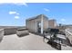 Rooftop deck with a hot tub, seating area, and stunning views of the city skyline at 15732 E Broncos Pl, Englewood, CO 80112