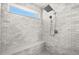 Walk-in shower featuring sleek tile walls, a bench, and modern shower fixtures at 15732 E Broncos Pl, Englewood, CO 80112