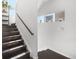 Staircase with dark wood steps, white walls, and a contemporary design at 15732 E Broncos Pl, Englewood, CO 80112