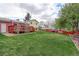 Large backyard showcasing a well-maintained lawn, deck, and privacy fence, ideal for Gathering gatherings and play at 10538 Quivas St, Northglenn, CO 80234