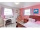 Bright bedroom with large windows, carpeted floors, and cute pink and lavender decor at 10538 Quivas St, Northglenn, CO 80234