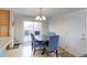 Dining space features hardwood floors, sliding glass door and modern chandelier at 10538 Quivas St, Northglenn, CO 80234
